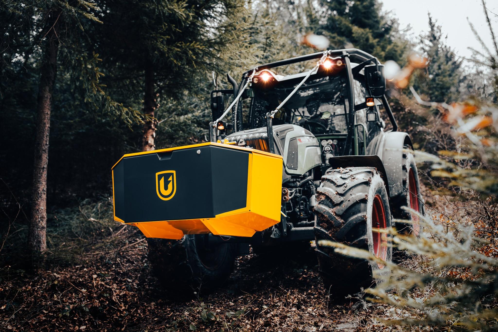 Uniforest Unibox transport box mounted on a tractor in an autumn forest