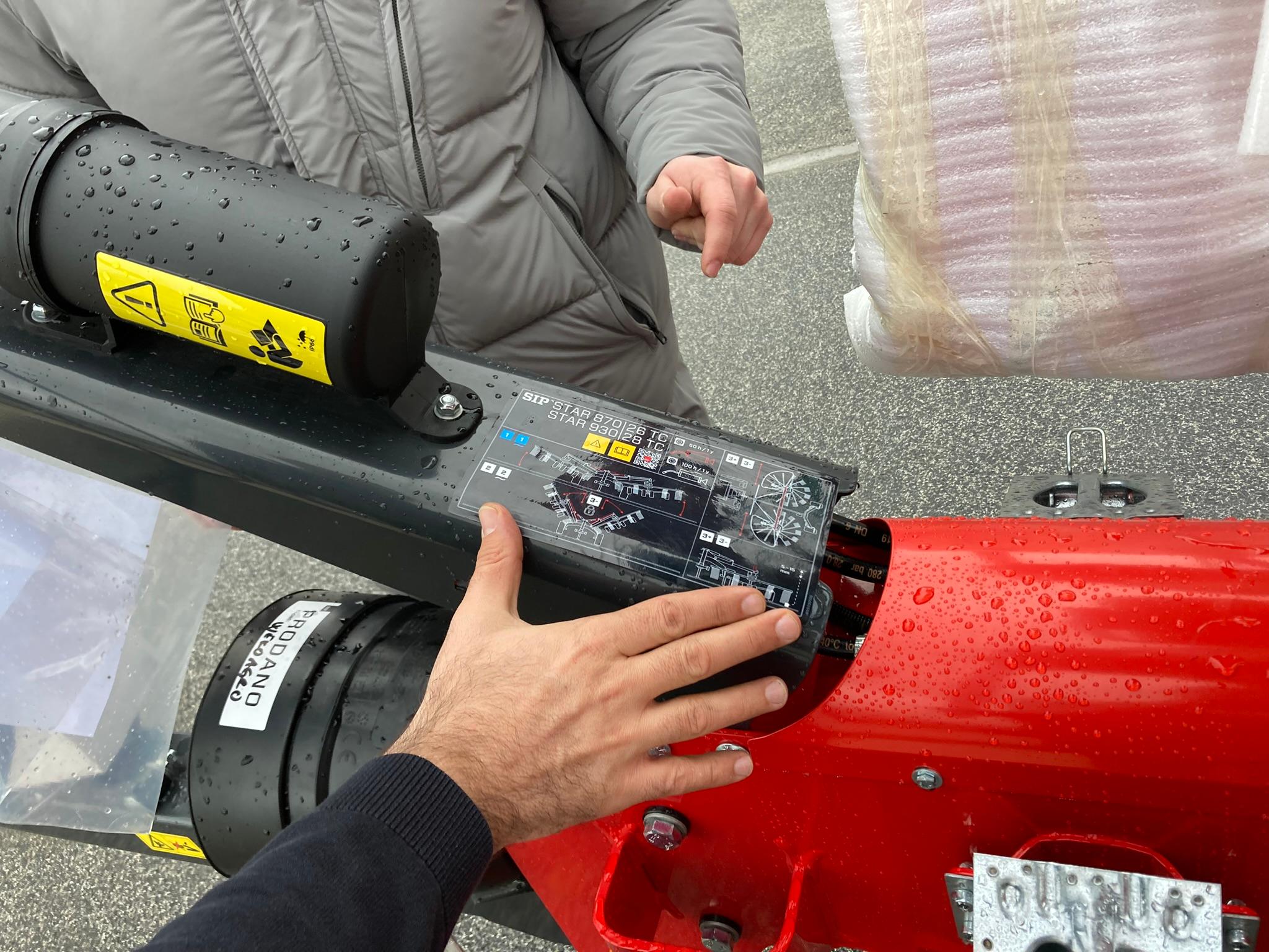 Hand on the control panel of a SIP machine during a review