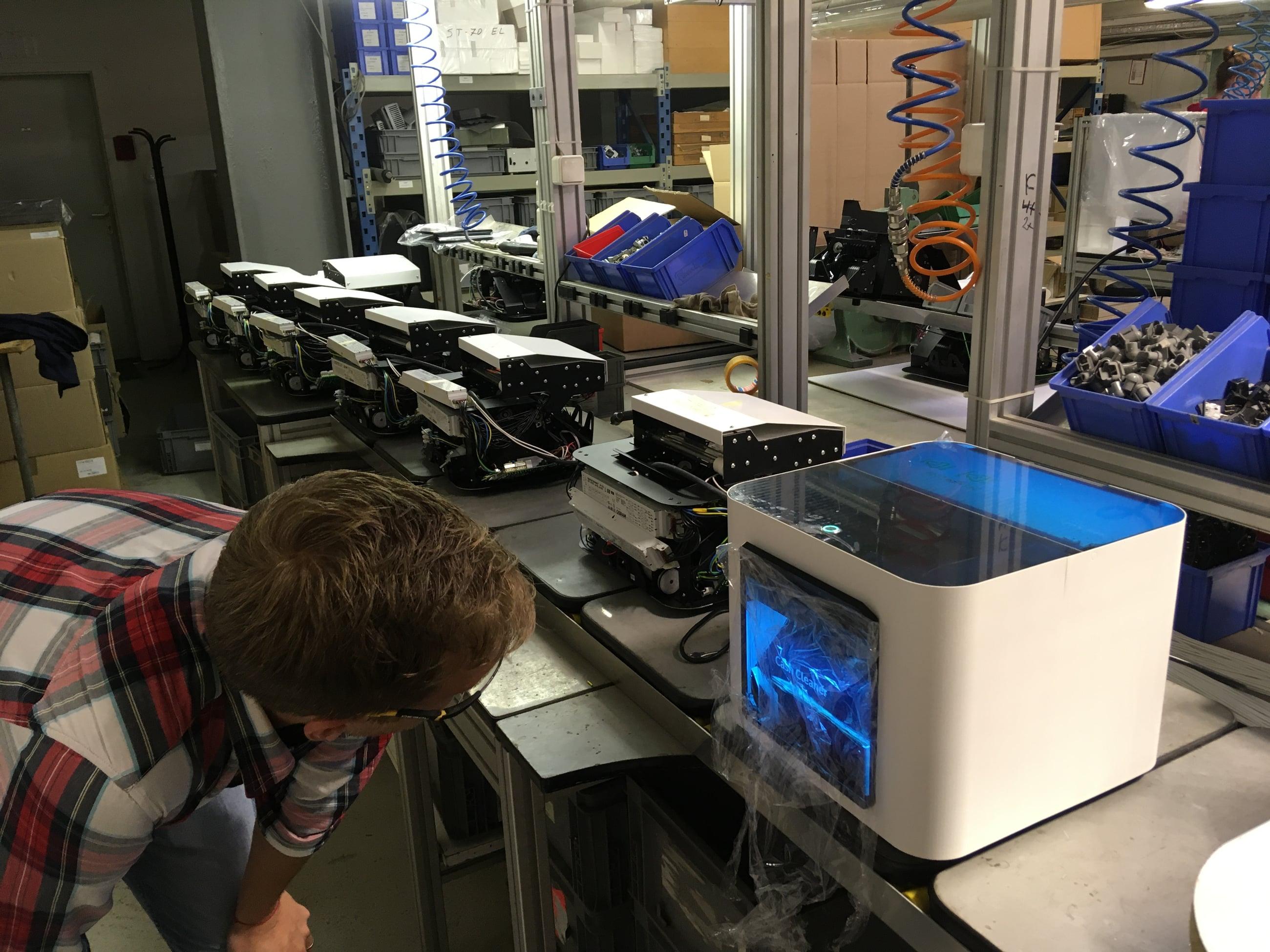 Engineer checking Cash Cleaner units on the assembly line
