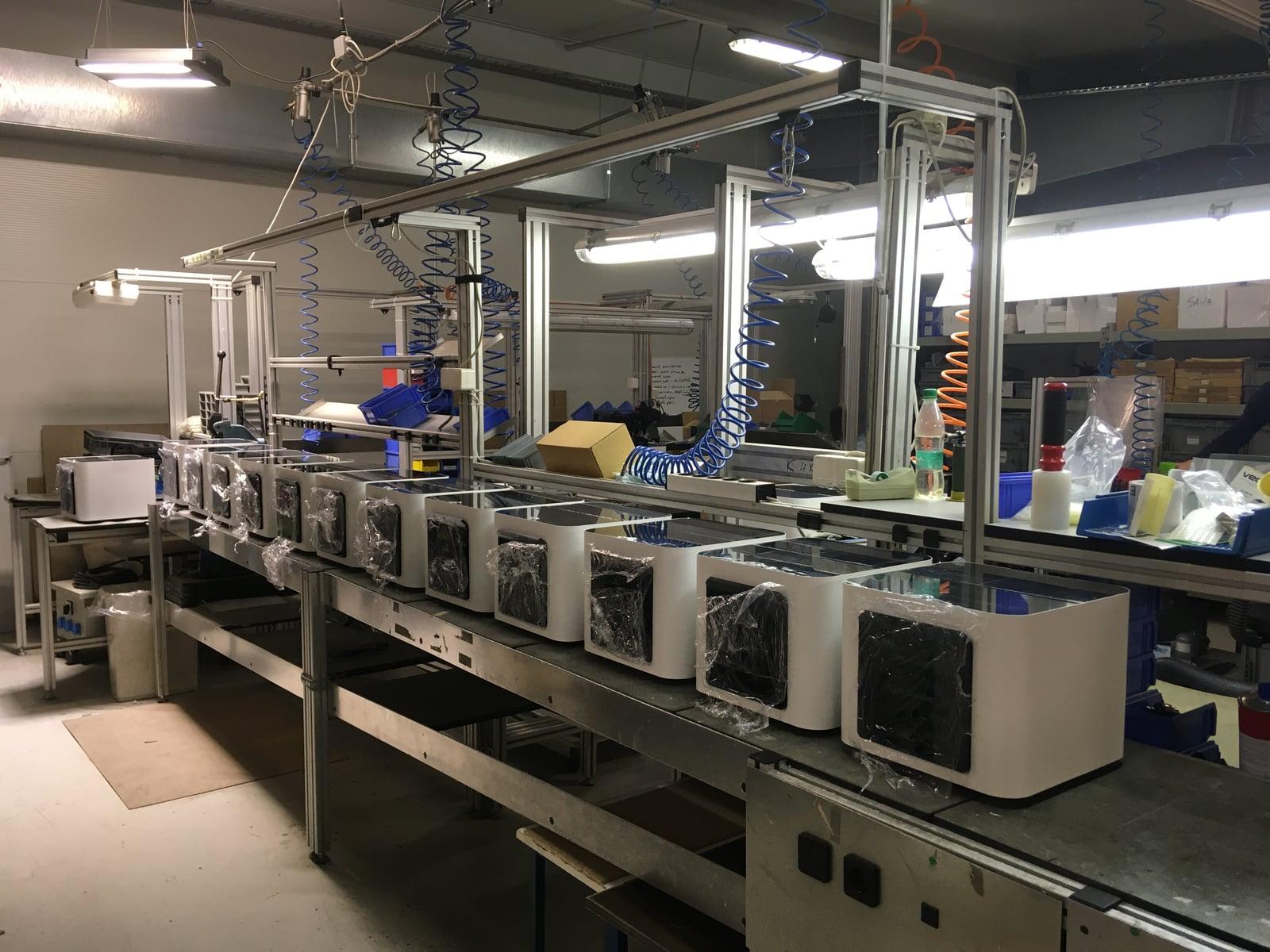 Row of finished Cash Cleaner units on the assembly line