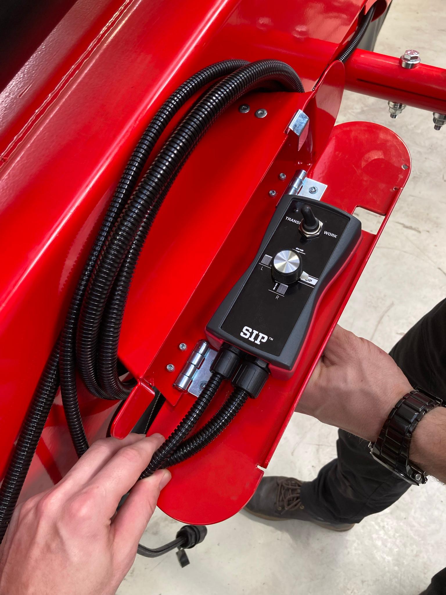 SIP control box with a dial being fitted to the red machine frame