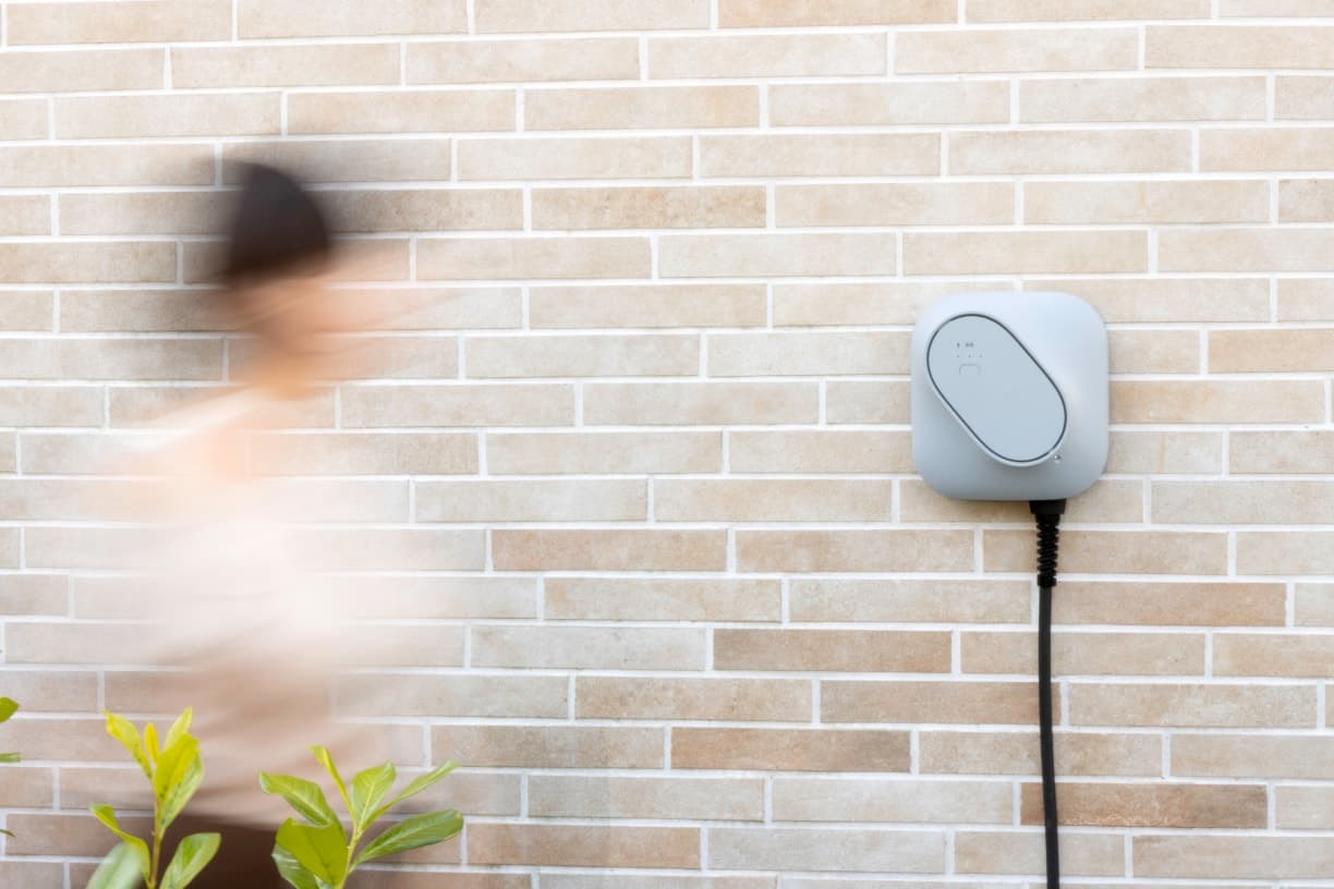 Etrel INCH Core charger mounted on a brick wall