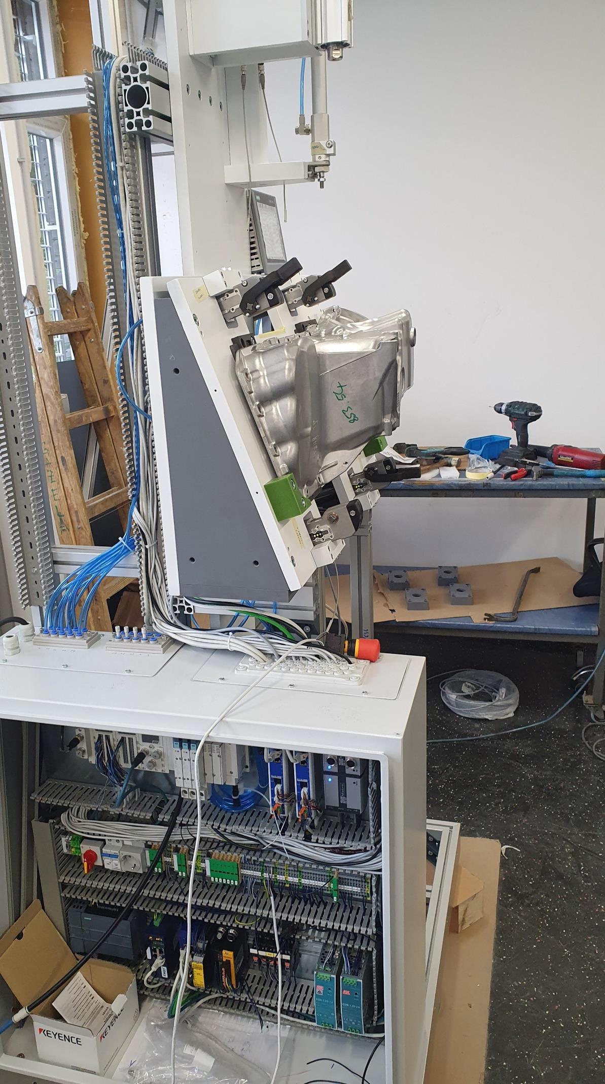 Inside of the booth prototype with the measuring unit, wiring and control cabinet exposed during assembly