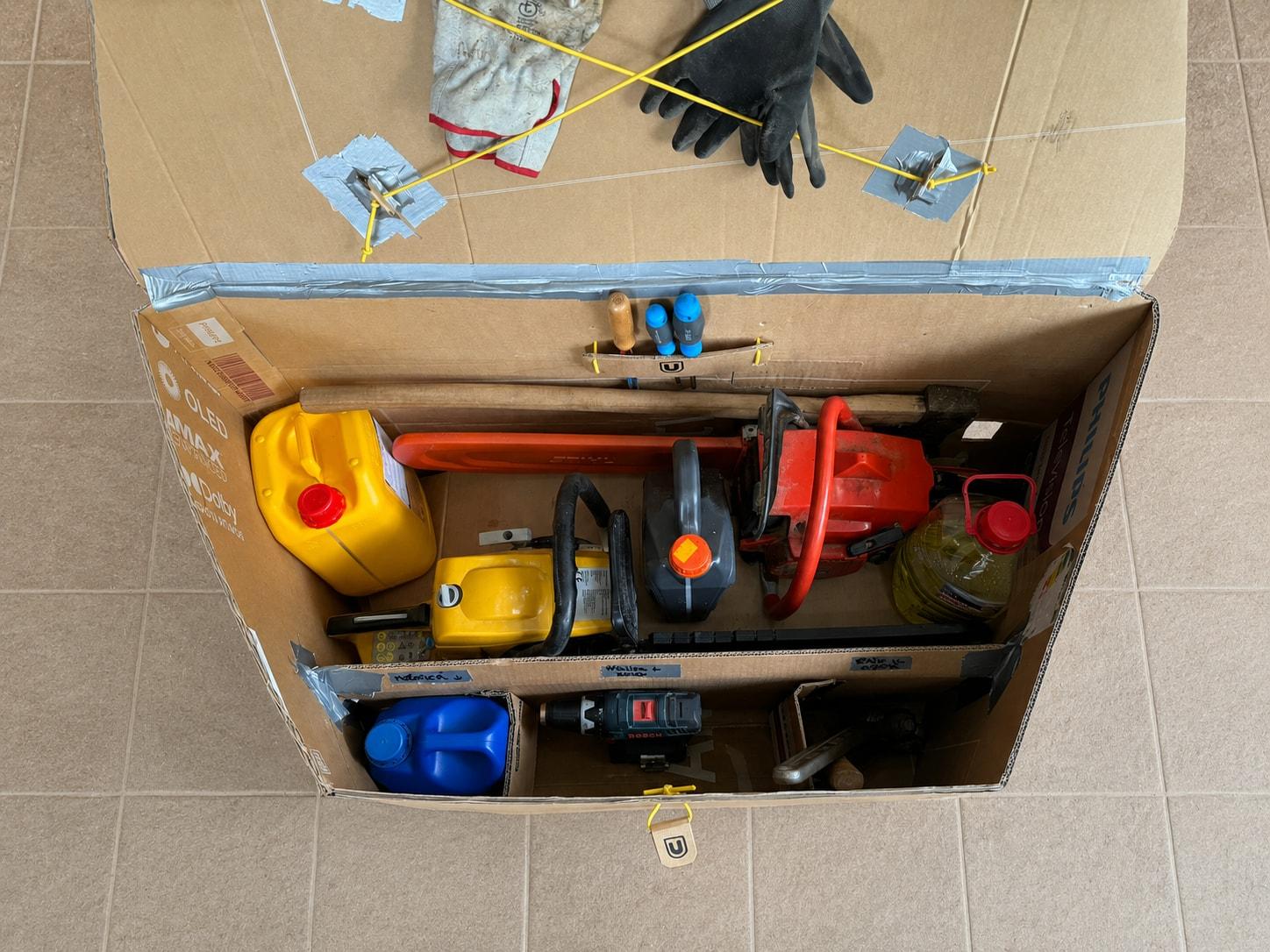 Cardboard Unibox prototype packed with tools, seen from above