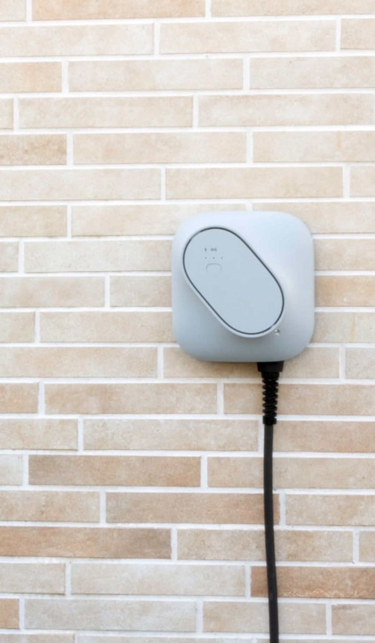Etrel INCH Core charger mounted on a brick wall